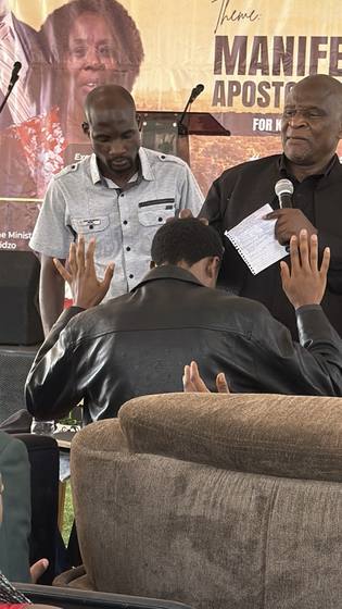 Ministers praying over the congregation