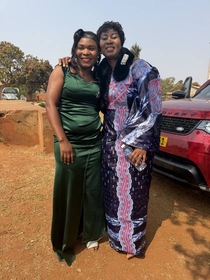 Two women of the church outside the tent