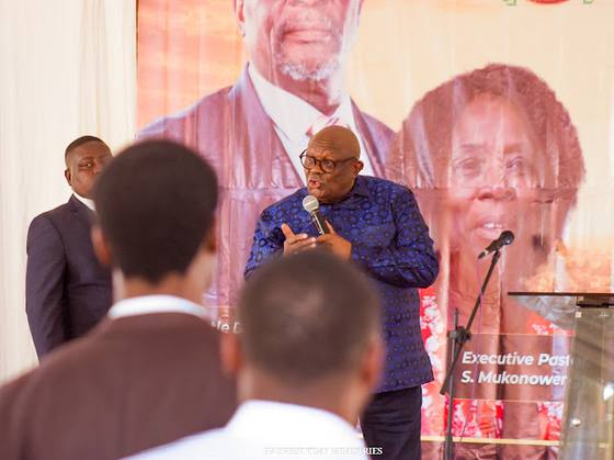 A minister preaching beneath the conference banner